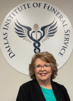 Melinda Kurtz smiling in front of the DIFS logo